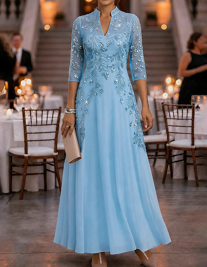 Champagne-colored maxi dress made of chiffon and mesh with golden sequins, floral print, and 3/4 sleeves