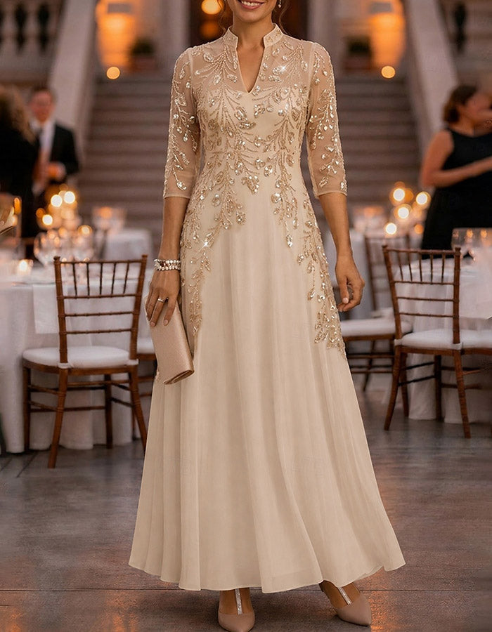 Champagne-colored maxi dress made of chiffon and mesh with golden sequins, floral print, and 3/4 sleeves