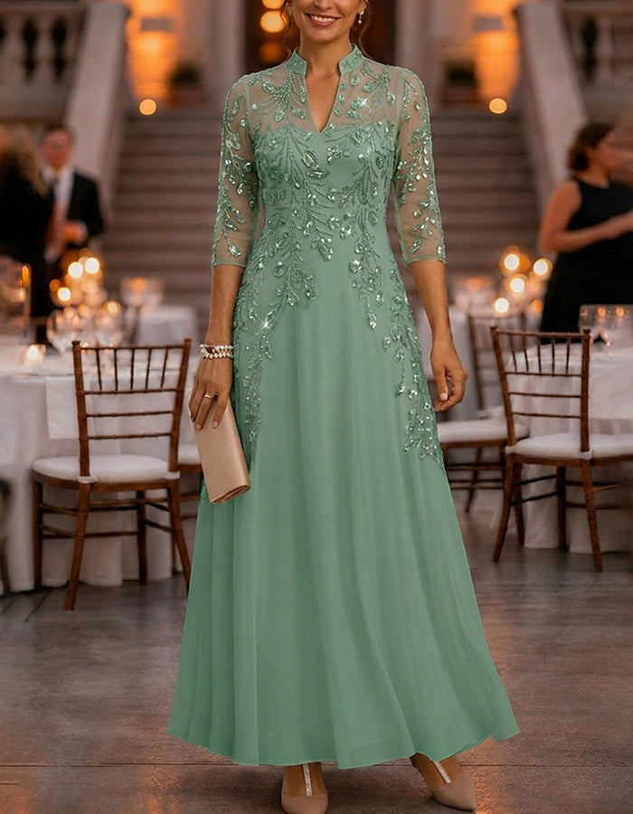 Champagne-colored maxi dress made of chiffon and mesh with golden sequins, floral print, and 3/4 sleeves