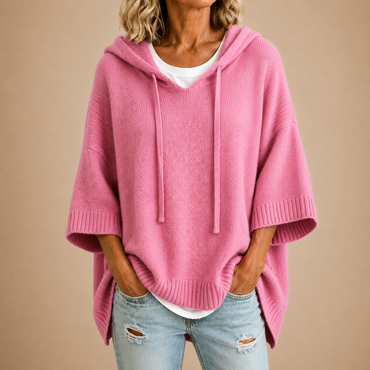 Oriana knitted poncho, back view with the hood down